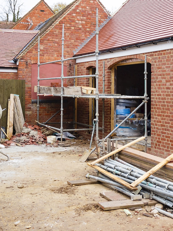Building site in UK with brick house extension under construction